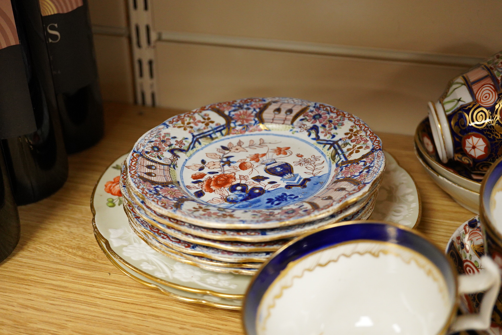 A 19th century Derby Imari pattern part tea set including a teapot a pair of 19th century botanical dishes and six small ironstone dishes.